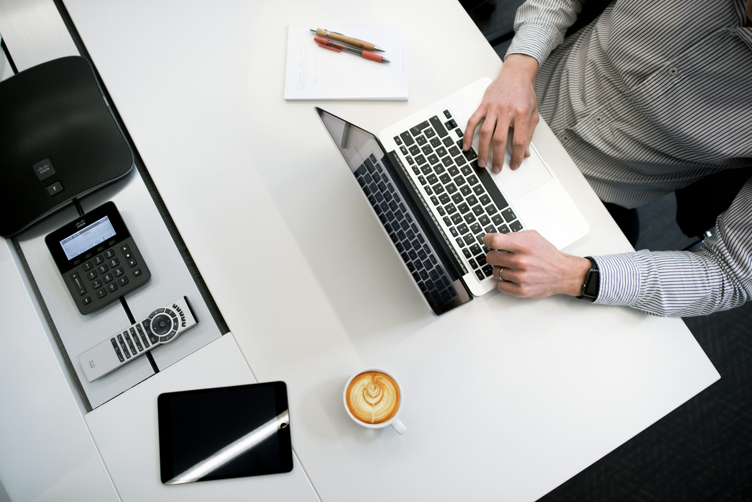 Person working on a laptop in a bright office